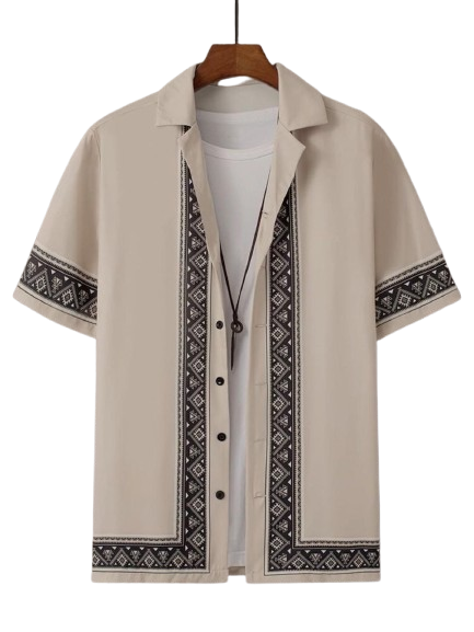 White short-sleeve shirt with black geometric embroidered trim on a wooden hanger.